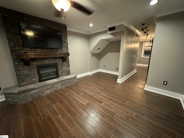 unfurnished living room with ceiling fan, a fireplace, baseboards, and wood tiled floor