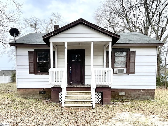 bungalow-style home with crawl space, covered porch, and a shingled roof