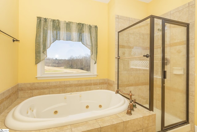 full bath featuring a stall shower and a whirlpool tub