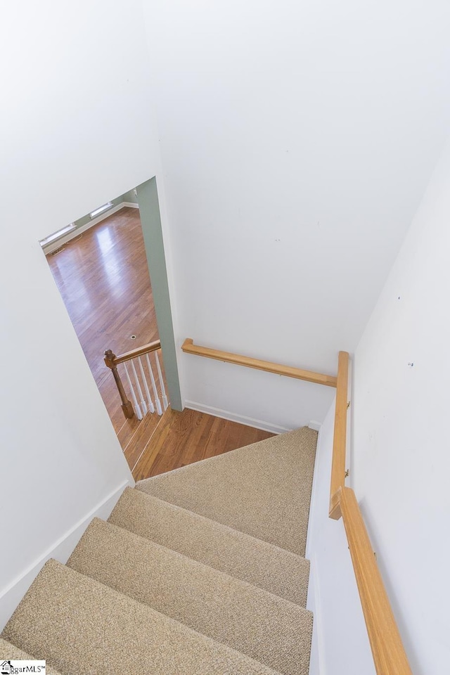 stairway featuring wood finished floors