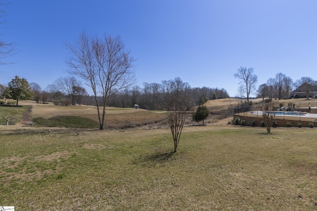 view of yard with a fenced in pool