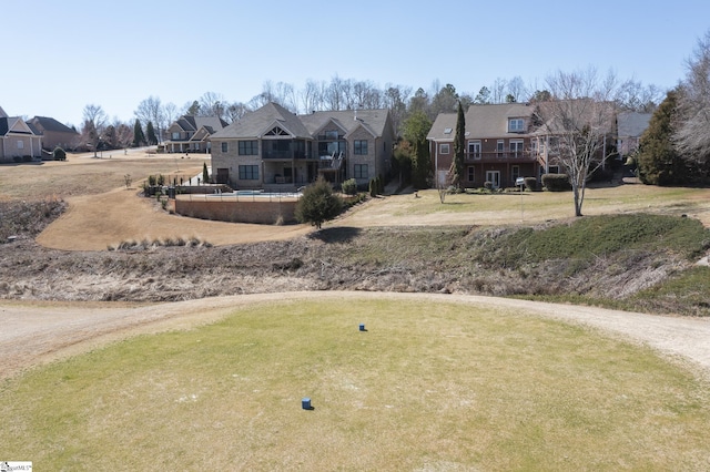 exterior space with a residential view and a front lawn