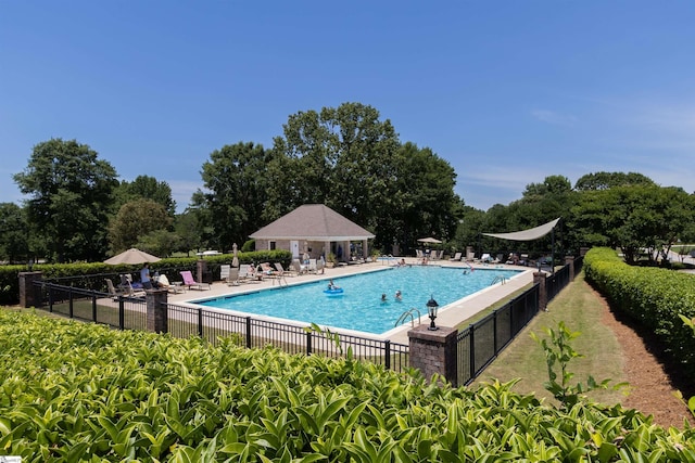 pool featuring a patio area and fence