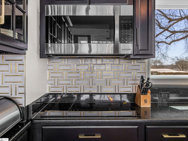 145 Dickson Rd, Campobello, SC 29322 - details featuring tasteful backsplash, stainless steel microwave, and dark brown cabinets