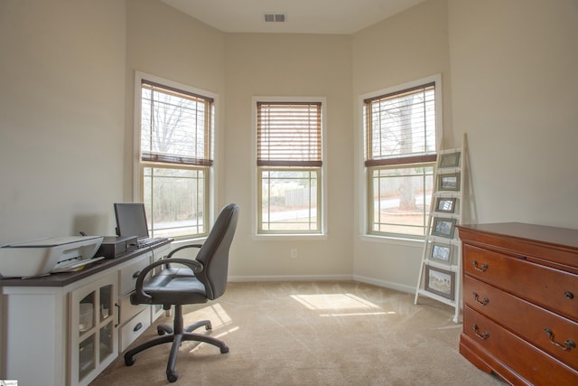 home office with visible vents, light colored carpet, and baseboards