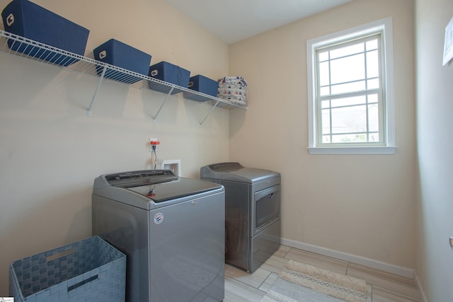 laundry area featuring baseboards, independent washer and dryer, and laundry area