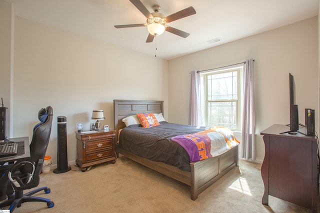 bedroom with a ceiling fan, light colored carpet, and visible vents