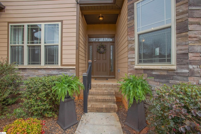 doorway to property featuring stone siding