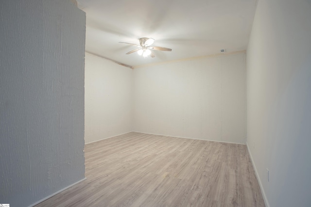 empty room featuring wood finished floors and a ceiling fan