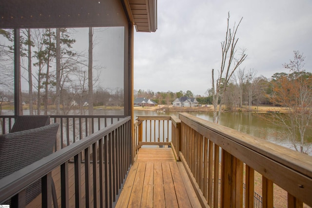 wooden deck featuring a water view