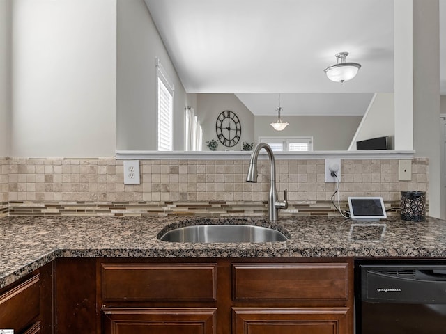 kitchen with dishwasher, plenty of natural light, backsplash, and a sink