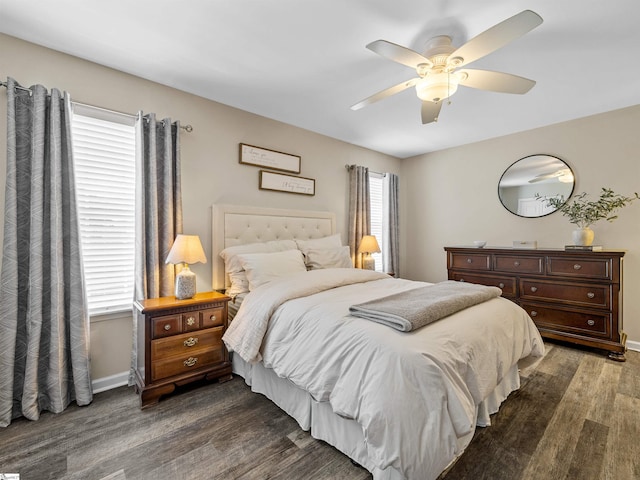 bedroom featuring baseboards, dark wood-type flooring, and ceiling fan