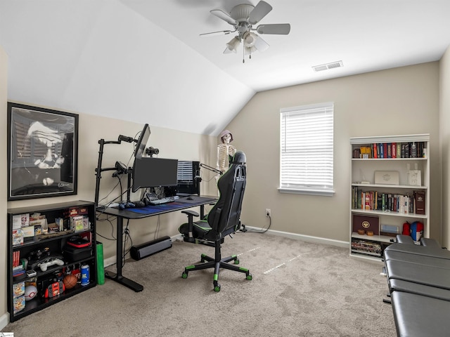 office area featuring a ceiling fan, visible vents, baseboards, lofted ceiling, and carpet flooring