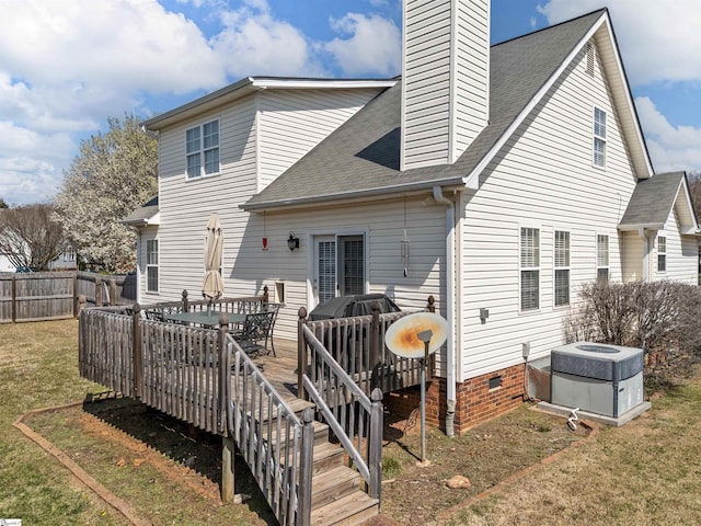 back of house featuring central air condition unit, fence, a yard, a shingled roof, and a chimney