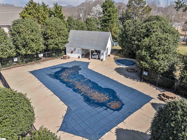 pool featuring a patio area, a storage structure, an outbuilding, and fence