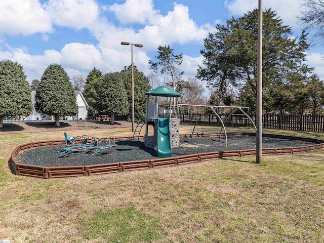 community play area with a yard and fence