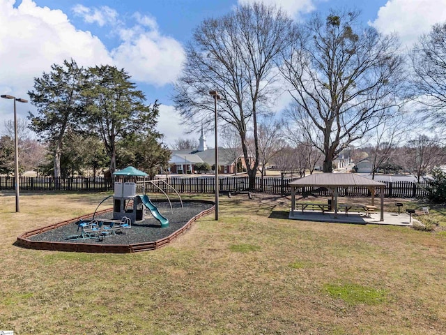 view of yard featuring a gazebo, playground community, and fence