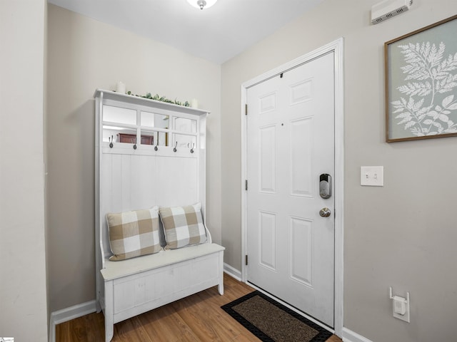 mudroom with visible vents, baseboards, and wood finished floors