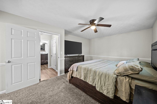 bedroom with carpet flooring, a textured ceiling, and baseboards