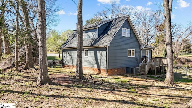 view of home's exterior featuring fence, a shingled roof, stairs, crawl space, and central air condition unit