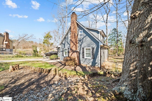 view of home's exterior with fence and a chimney