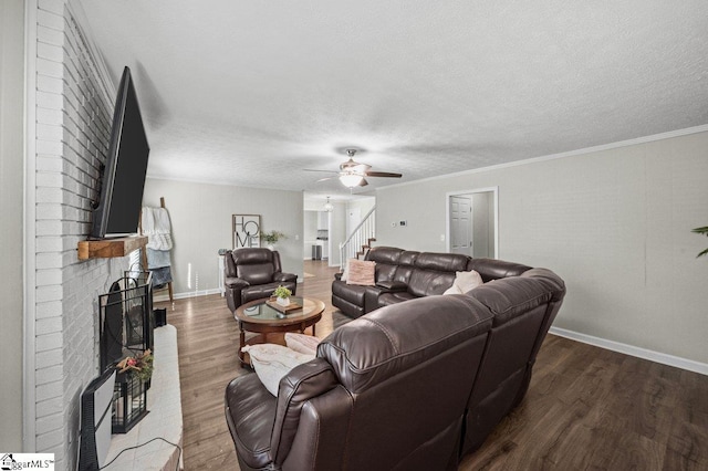 living area with ornamental molding, a textured ceiling, ceiling fan, and dark wood-style flooring