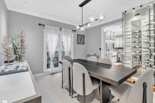 dining area featuring a chandelier, baseboards, and ornamental molding