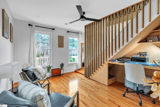 office featuring visible vents, baseboards, ceiling fan, and wood finished floors