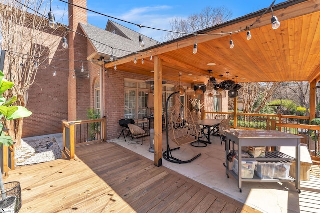 wooden terrace with outdoor dining space