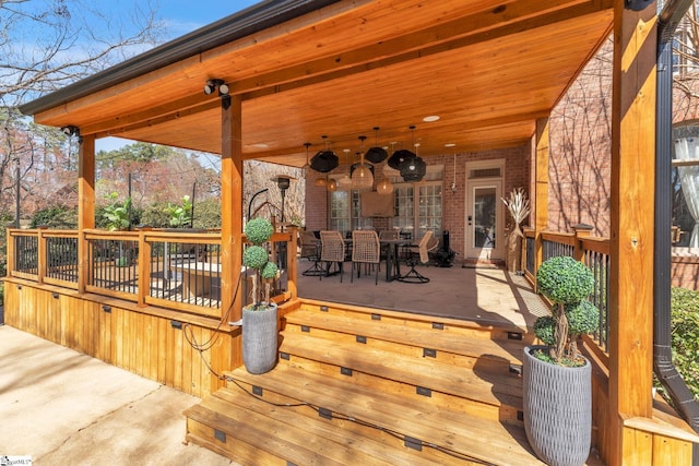 wooden terrace with outdoor dining area