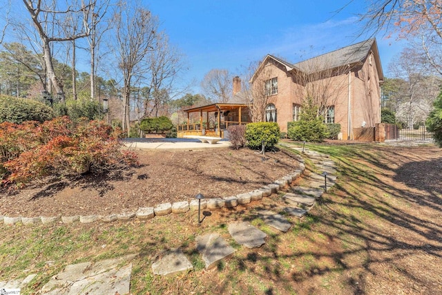 back of property with stucco siding, a yard, and fence