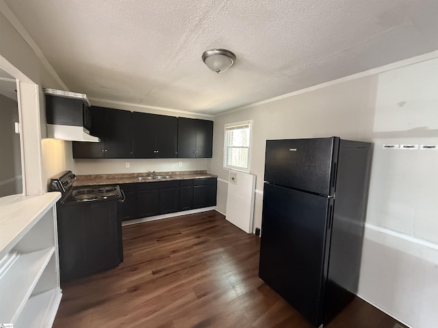 kitchen featuring dark wood-type flooring, black appliances, a sink, under cabinet range hood, and dark cabinets