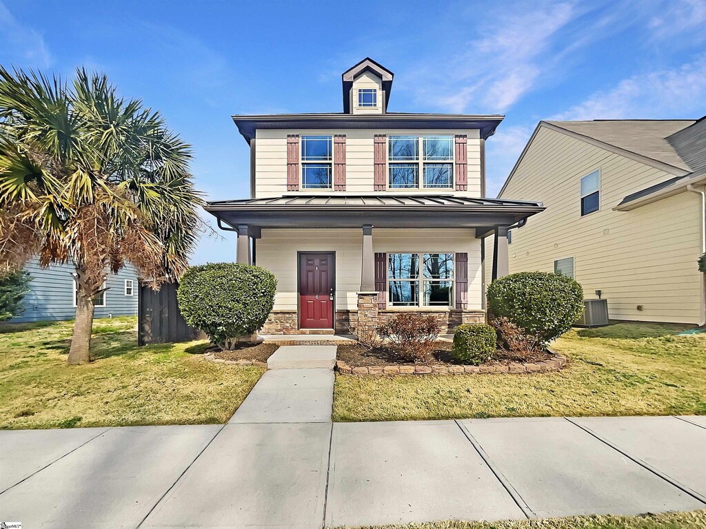 6 Ellis Mill St, Simpsonville, SC 29680 - view of front of home featuring a standing seam roof, stone siding, a porch, a front yard, and metal roof