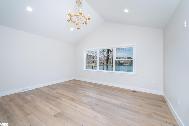 unfurnished room with light wood-style flooring, baseboards, visible vents, and a chandelier