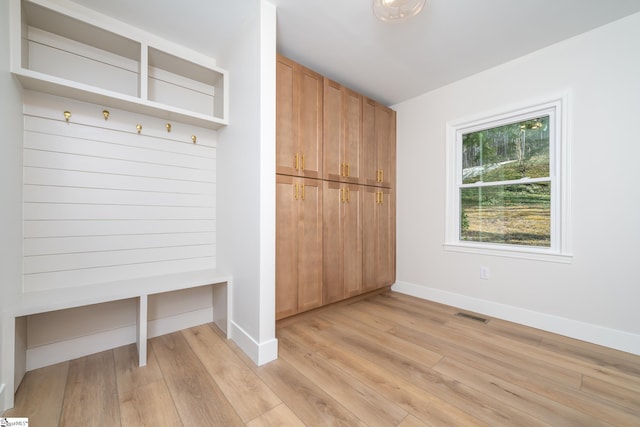 mudroom featuring visible vents, baseboards, and light wood-type flooring