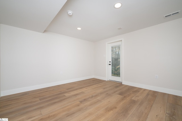 unfurnished room featuring light wood finished floors, visible vents, recessed lighting, and baseboards