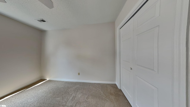 20 Woodbine Ct, Spartanburg, SC 29307 - unfurnished bedroom with visible vents, baseboards, carpet floors, a closet, and a textured ceiling