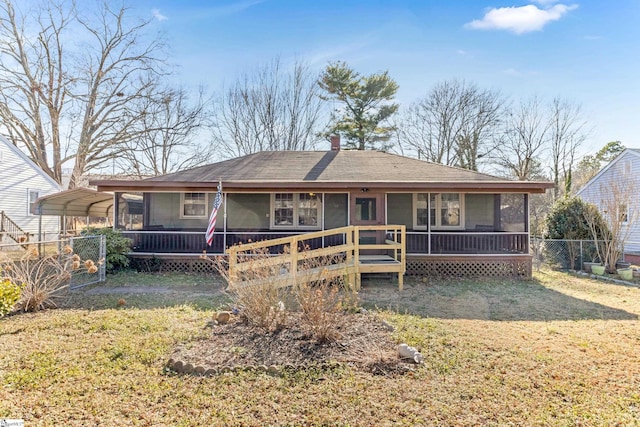 203 Givens St, Fountain Inn, SC 29644 - back of property featuring a detached carport, a lawn, fence, and a sunroom