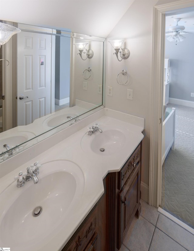bathroom with tile patterned flooring, a ceiling fan, and a sink