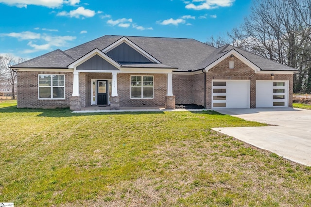 313 Barker Rd, Simpsonville, SC 29680 - view of front of house featuring a front yard, driveway, an attached garage, brick siding, and board and batten siding