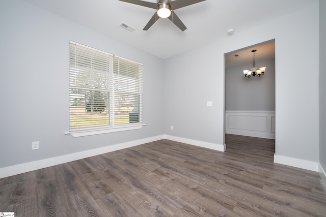 313 Barker Rd, Simpsonville, SC 29680 - spare room featuring visible vents, baseboards, dark wood-type flooring, and ceiling fan with notable chandelier