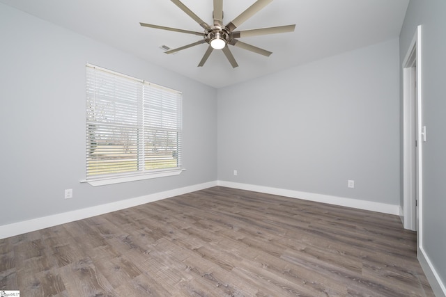 313 Barker Rd, Simpsonville, SC 29680 - spare room featuring wood finished floors, a ceiling fan, and baseboards