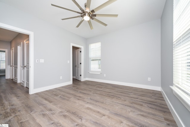 313 Barker Rd, Simpsonville, SC 29680 - empty room with wood finished floors, a ceiling fan, and baseboards