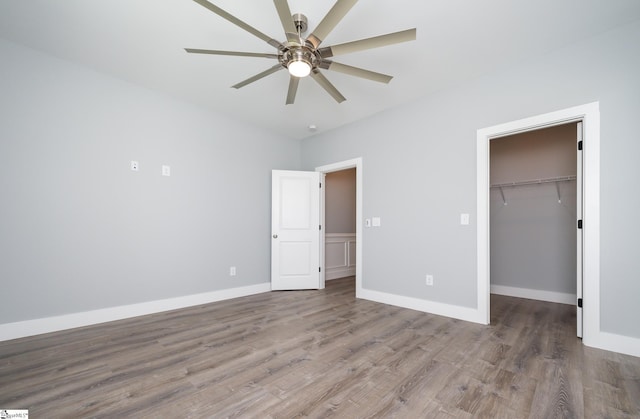 313 Barker Rd, Simpsonville, SC 29680 - unfurnished bedroom featuring a spacious closet, wood finished floors, baseboards, and a closet