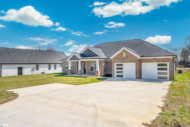 313 Barker Rd, Simpsonville, SC 29680 - view of front of house with driveway, a front lawn, a shingled roof, a garage, and brick siding