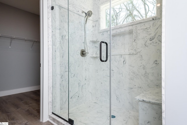 313 Barker Rd, Simpsonville, SC 29680 - bathroom with a marble finish shower, a walk in closet, baseboards, and wood finished floors