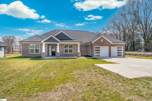 313 Barker Rd, Simpsonville, SC 29680 - view of front of house with a front yard, driveway, a shingled roof, a garage, and brick siding