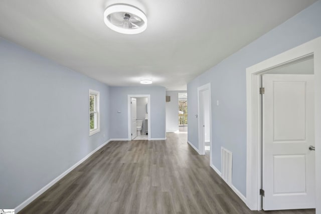 222 Poplar St, Gaffney, SC 29341 - corridor with visible vents, baseboards, a healthy amount of sunlight, and wood finished floors
