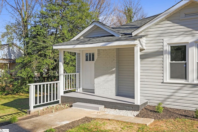 222 Poplar St, Gaffney, SC 29341 - view of exterior entry with covered porch, brick siding, and a shingled roof
