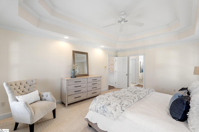 bedroom featuring light carpet, a raised ceiling, connected bathroom, crown molding, and baseboards